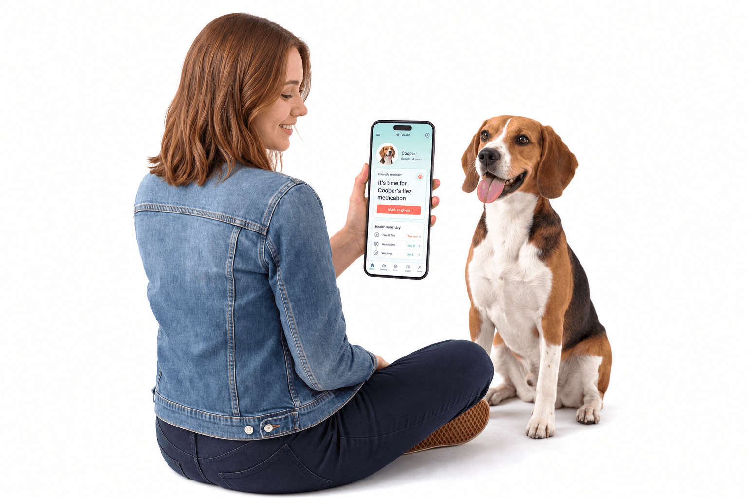 A dog owner checking her beagle’s PuppyDoc health record on her phone